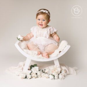 Photo of a newborn baby dressed in white