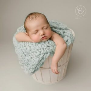 Photoshoot of a Newborn Baby Sat In basket