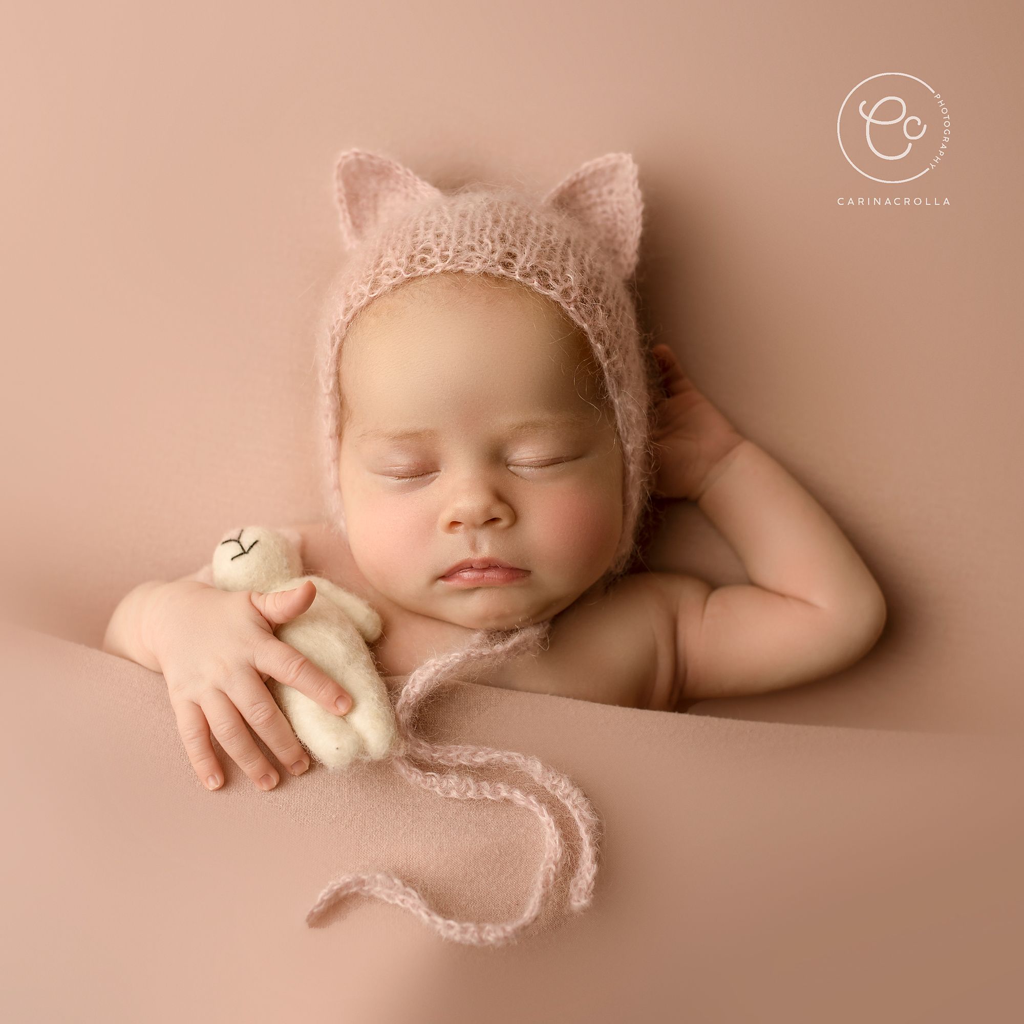 Photoshoot of Newborn baby in pink hat